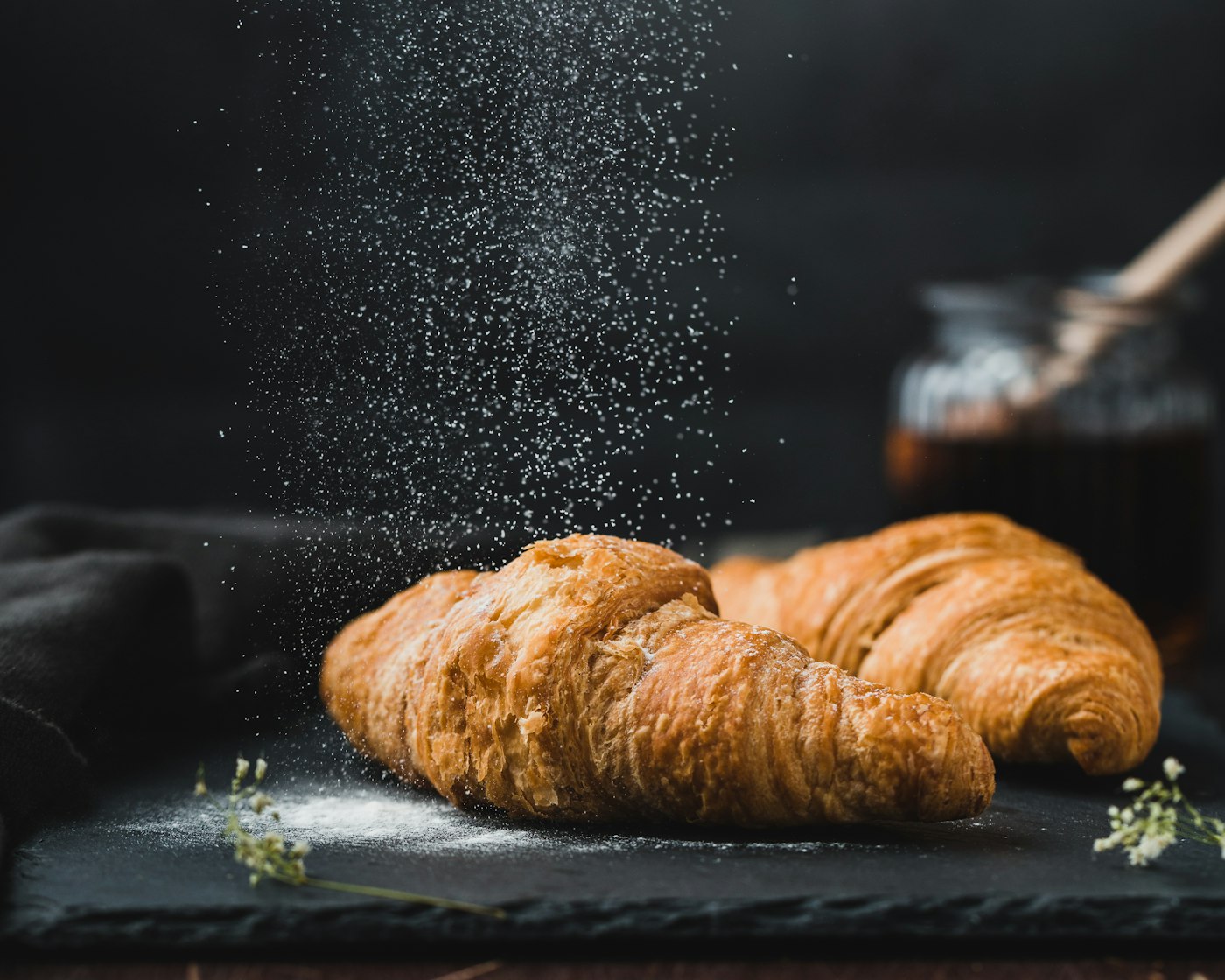 Fresh artisan baked croissants and cabinet pastries dusted with flour