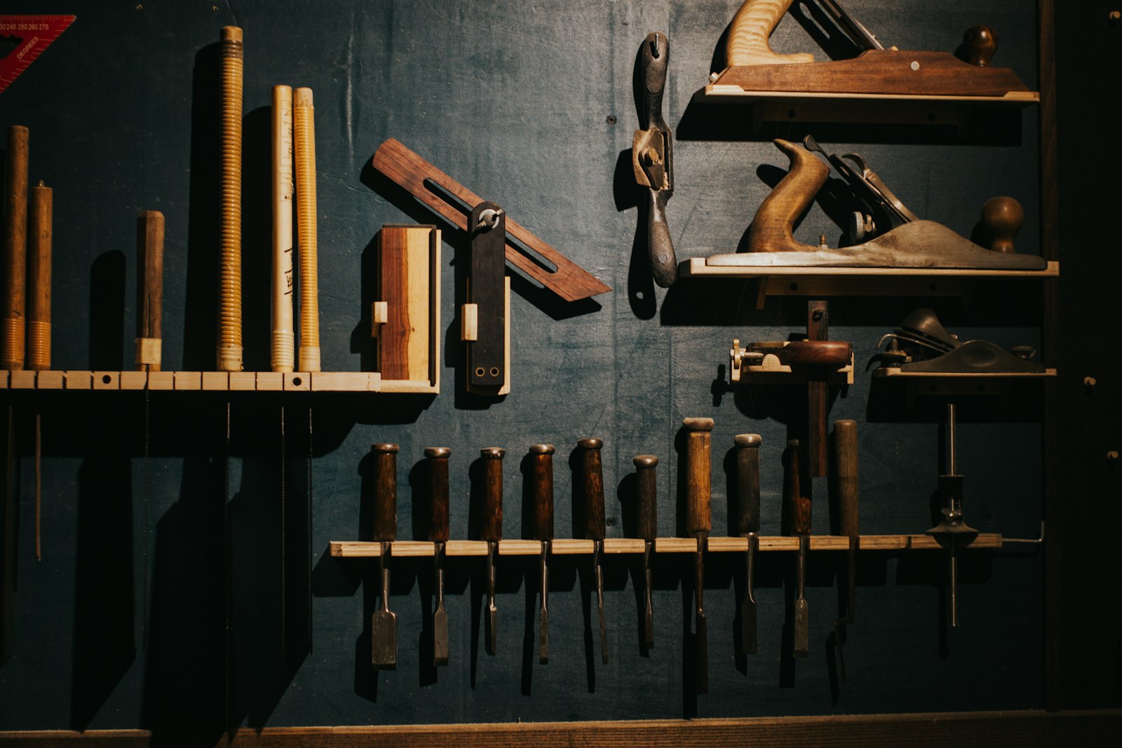 Organised hand tools and planes in a workshop rack